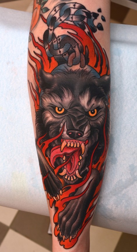 Amazing Colored Evil Hell Dog Tattoo On Forearm Stylized With Flames