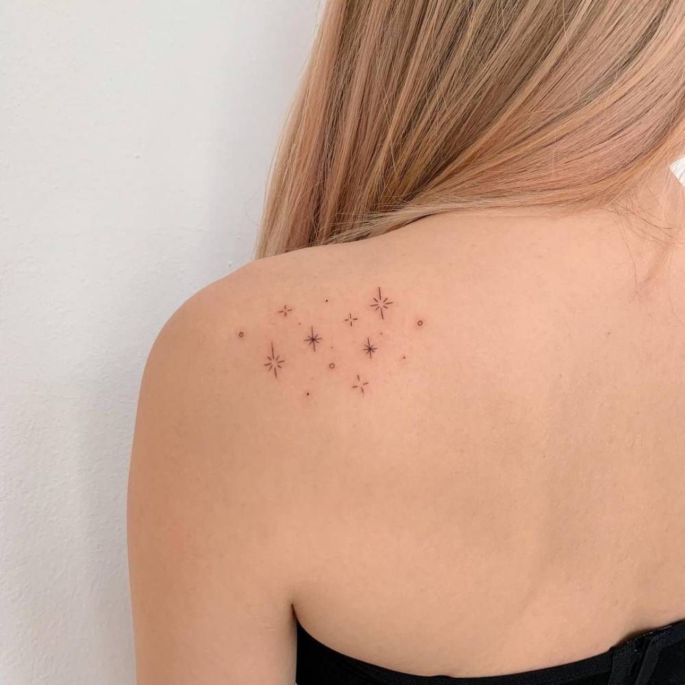 The Back Of A Woman S Shoulder With Small Stars On Her Left Arm And Chest